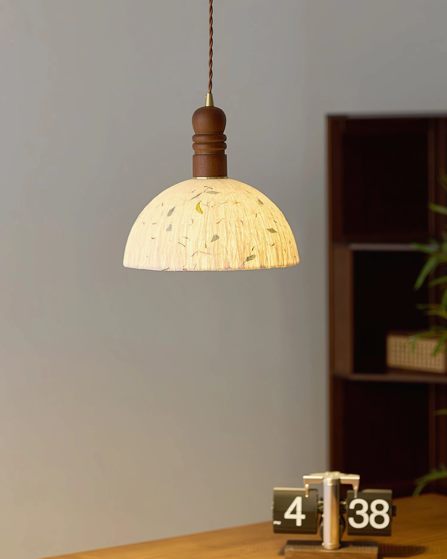 Diana pendant light with light yellow leaf-flecked dome shade illuminating wooden shelf corner