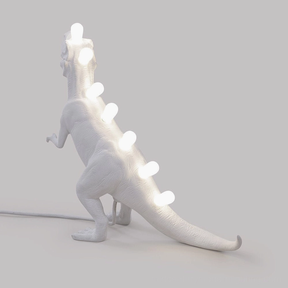 Dinosaur table lamp in creative studio, artistic lighting statement piece
