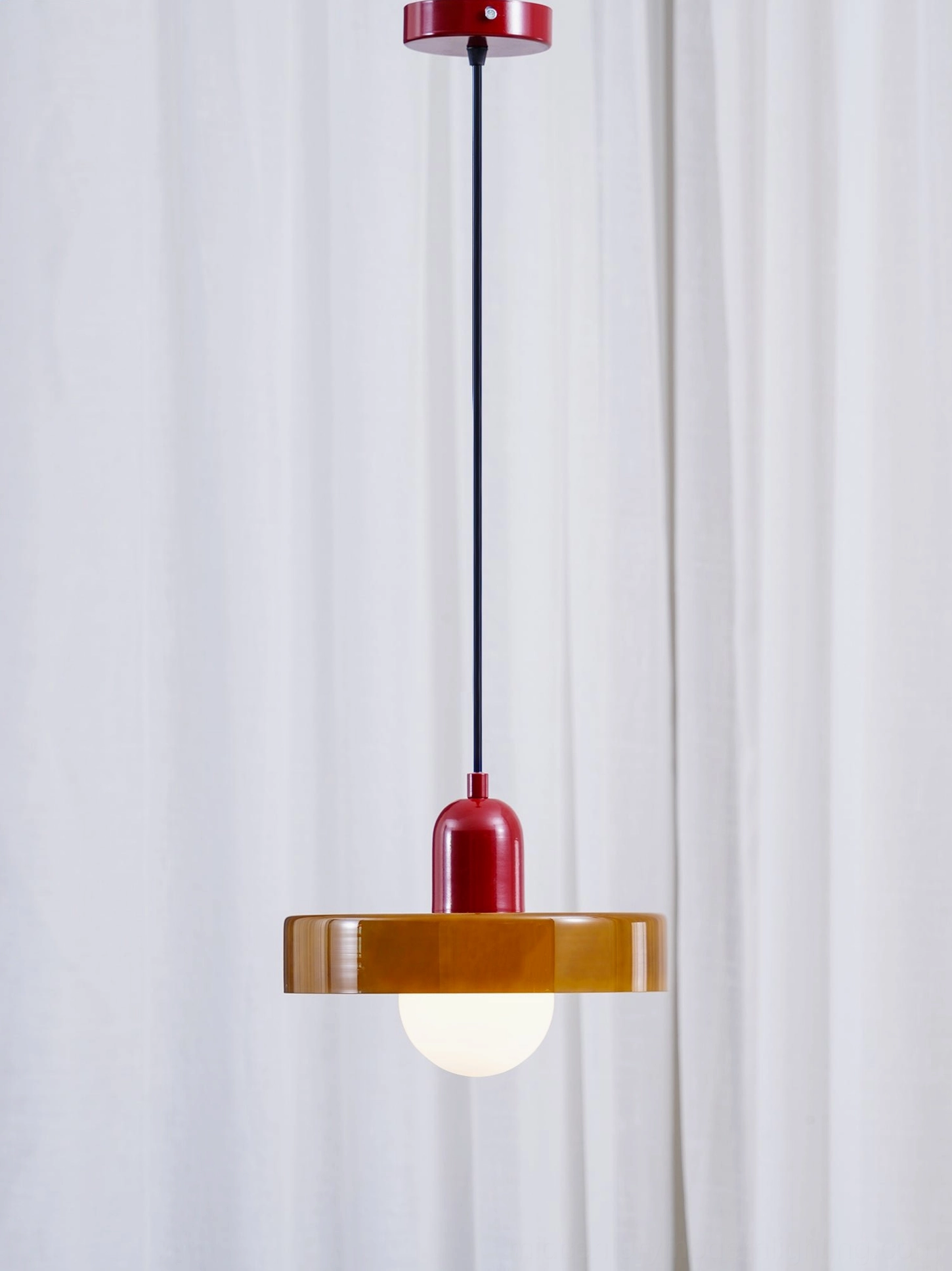 Disc Orb Pendant Light with exposed G9 bulb and illuminated frosted glass