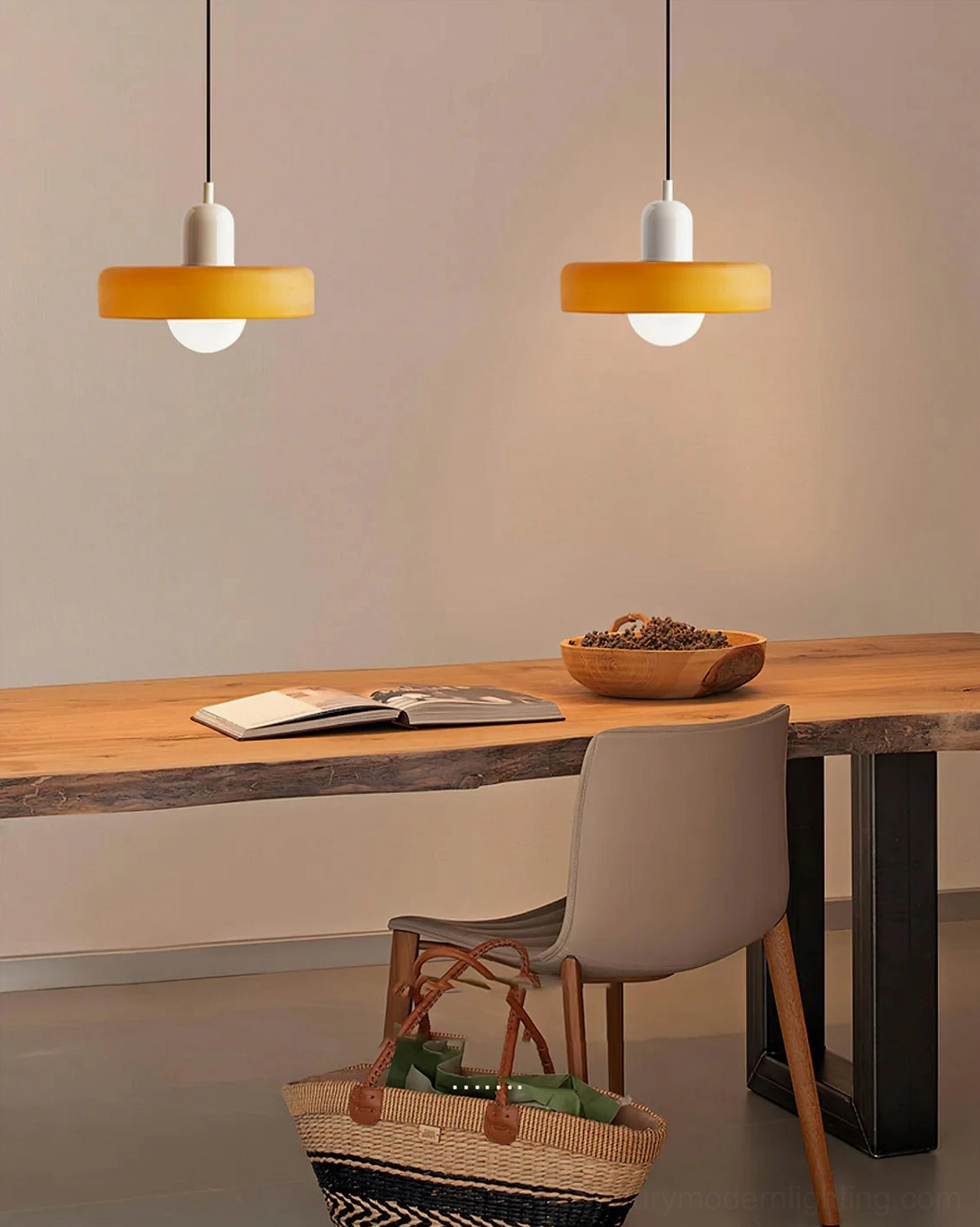 Two identical Disc Orb Pendant Lights in yellow finish above wooden desk in study space