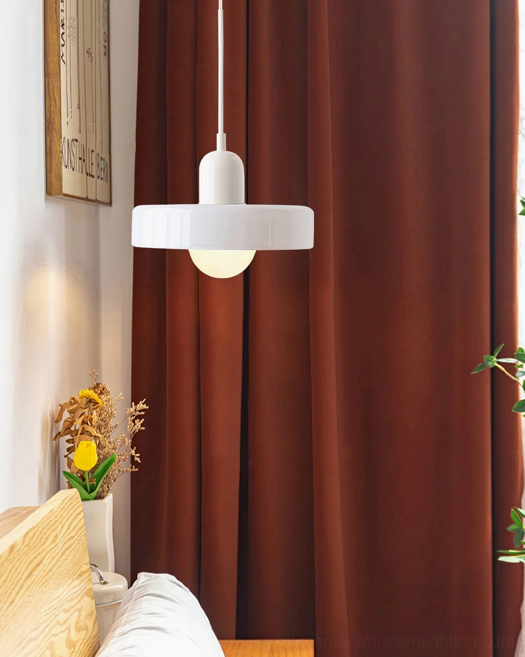 Single Disc Orb Pendant Light in neutral finish above cozy living room corner