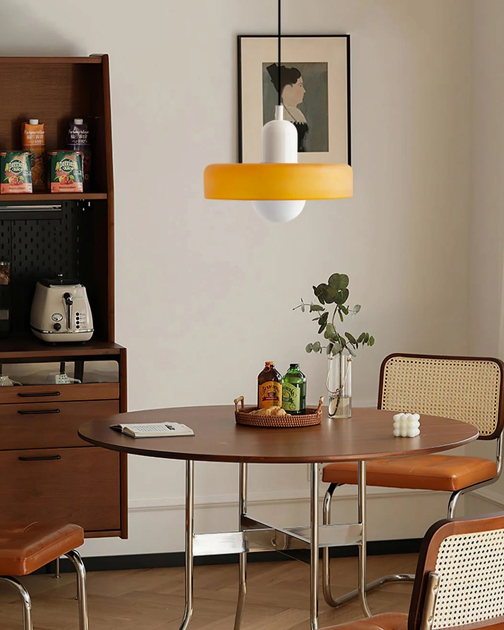 Disc Orb Pendant Light in warm yellow finish above mid-century modern dining nook