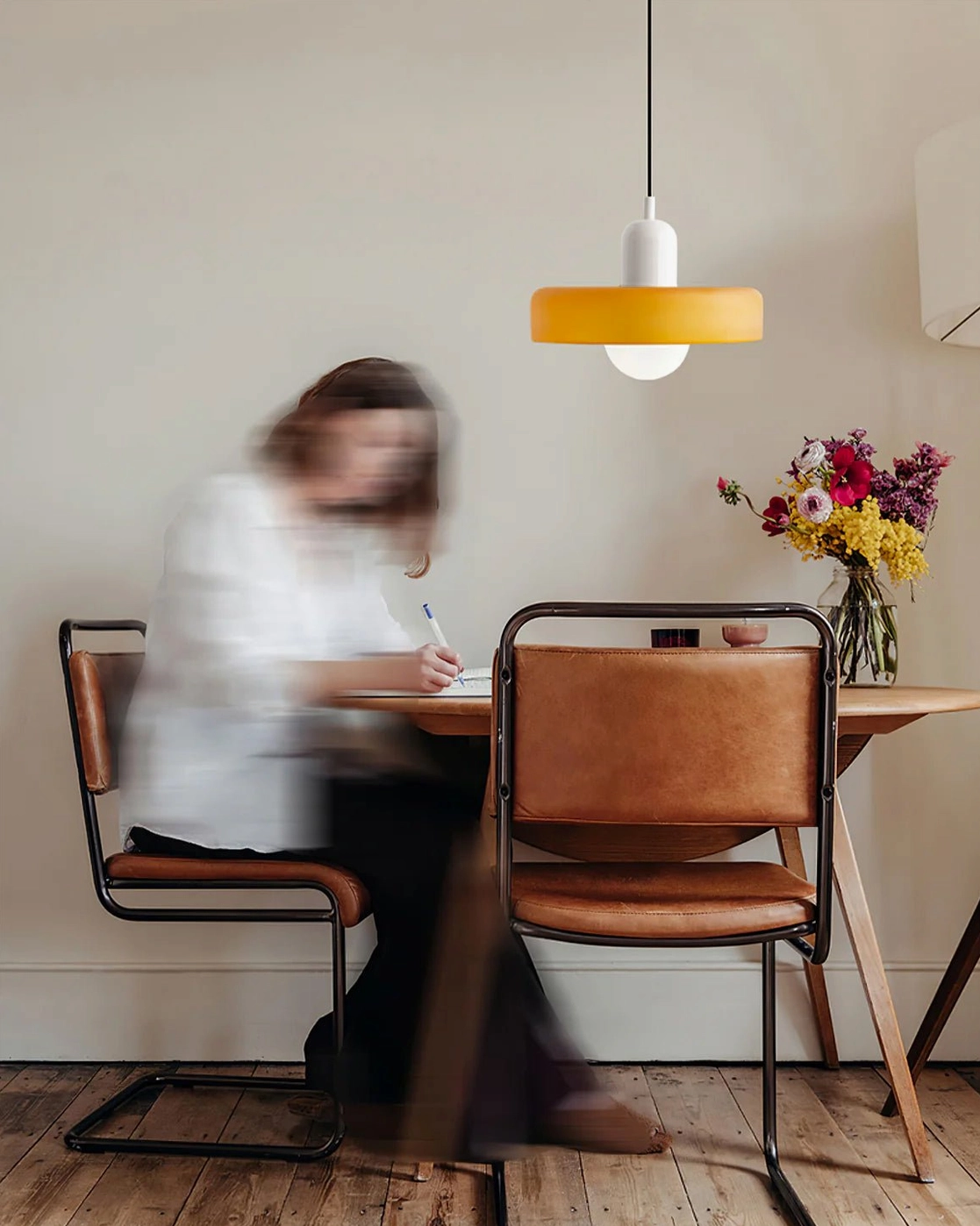 Disc Orb Pendant Light in white finish illuminating minimalist dining workspace