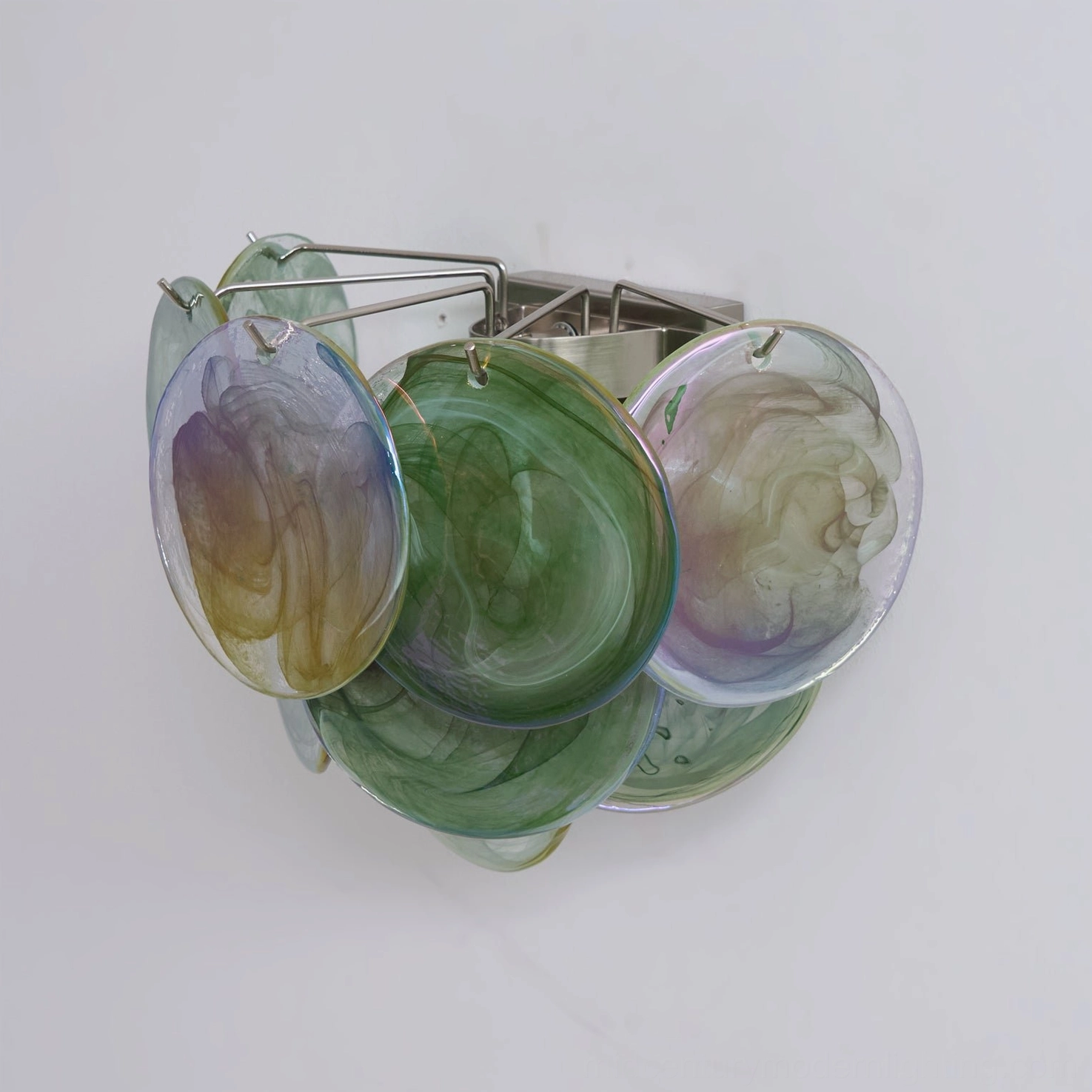 Disc wall lamp back view detail showing mixed green and purple tinted handcrafted glass discs, bottom flat angle