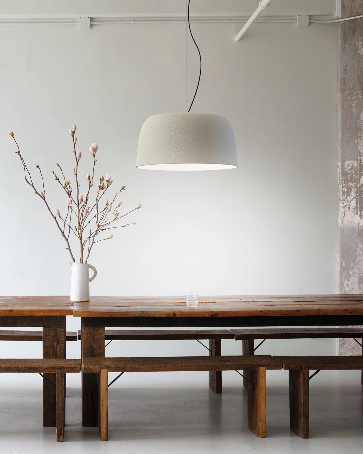 Djembe modern drum pendant lamp showing interior light diffusion and white reflective surface
