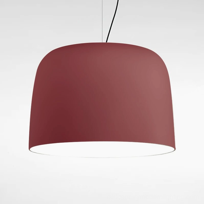 Red Djembe pendant lamp in large size suspended above dining table as vibrant design accent