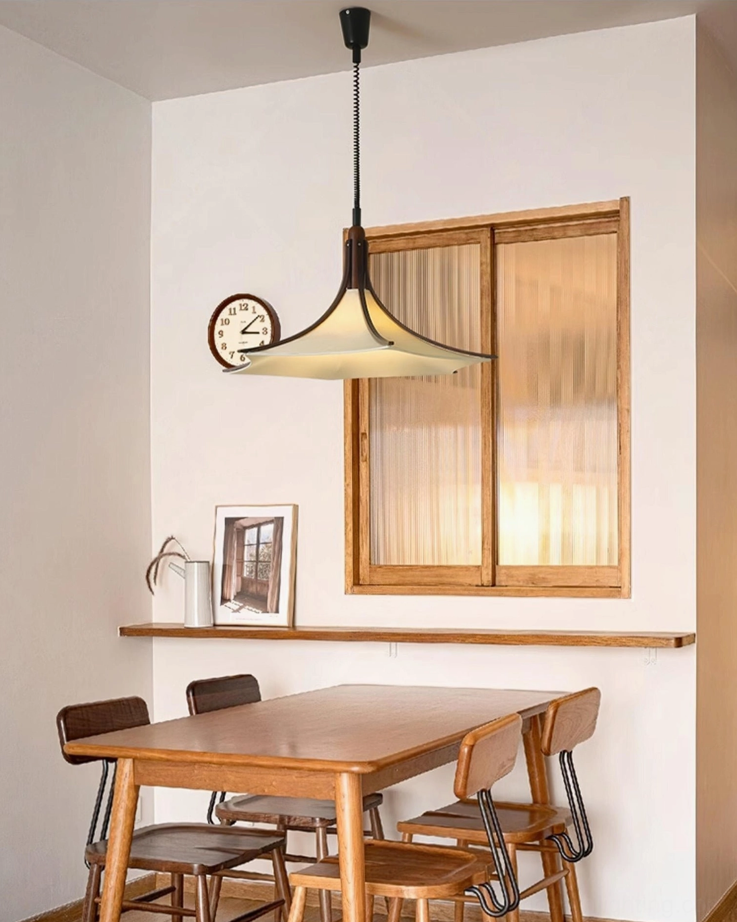 Mid-century modern pendant fixture coordinating with wooden dining set in formal dining room