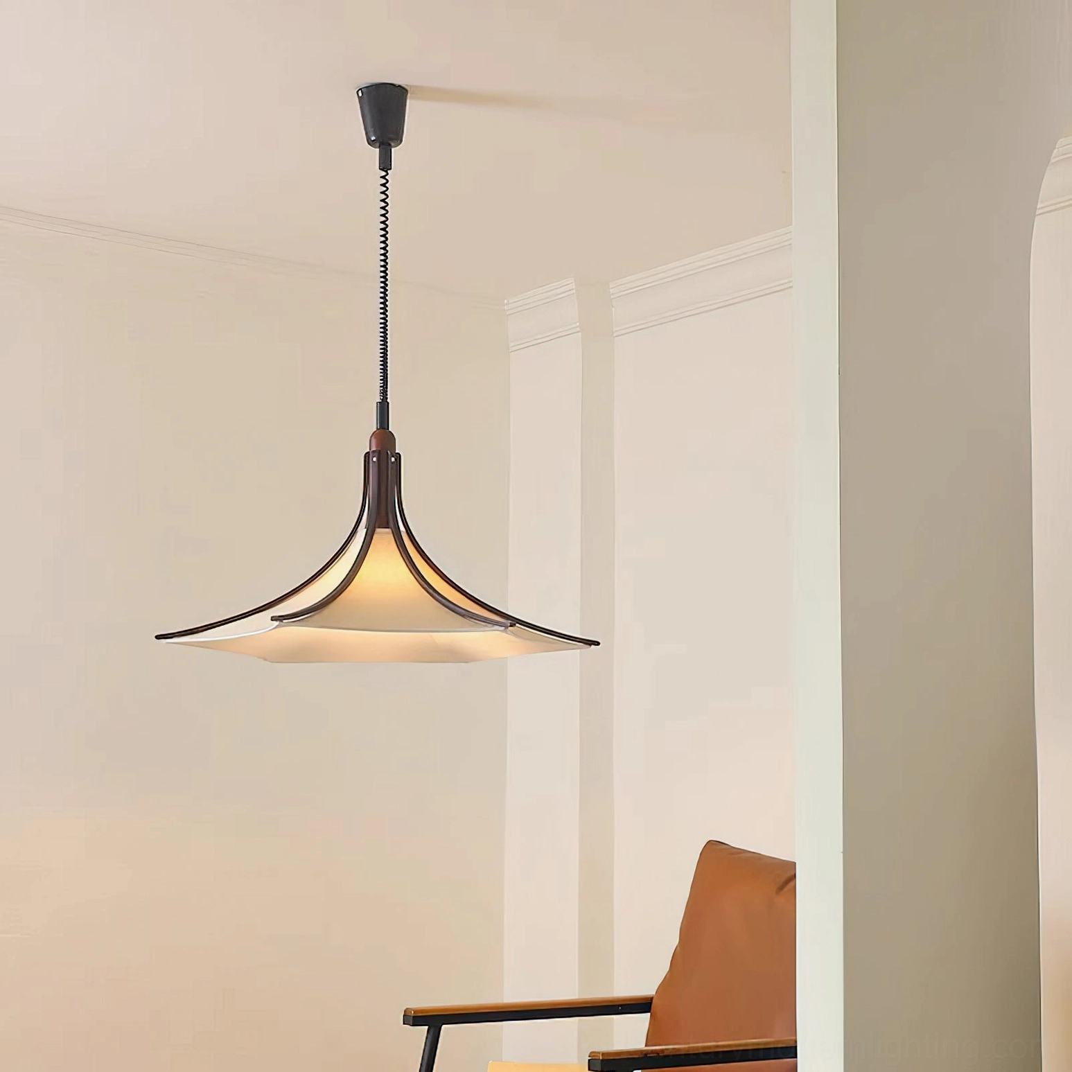 Mid-century modern pendant light in minimalist living room setting, three-quarter angle view showing fabric diffuser