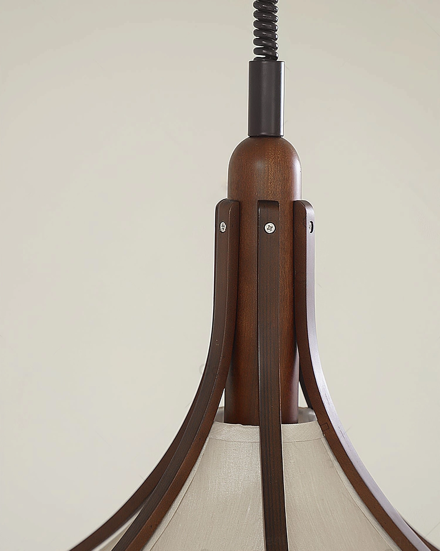 Walnut wood and fabric pendant light fixture mounted in contemporary home interior