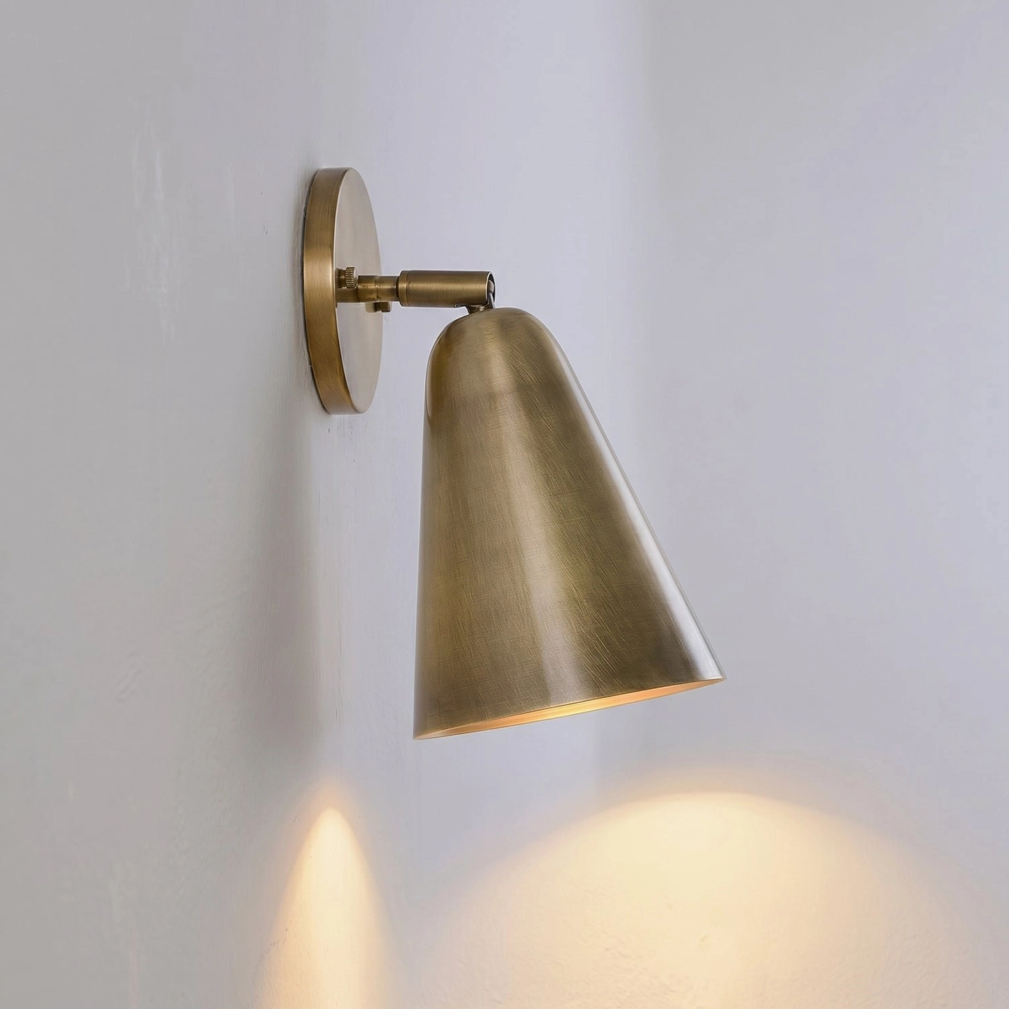 Donna mid-century modern wall sconce with functional swivel joint and clean design