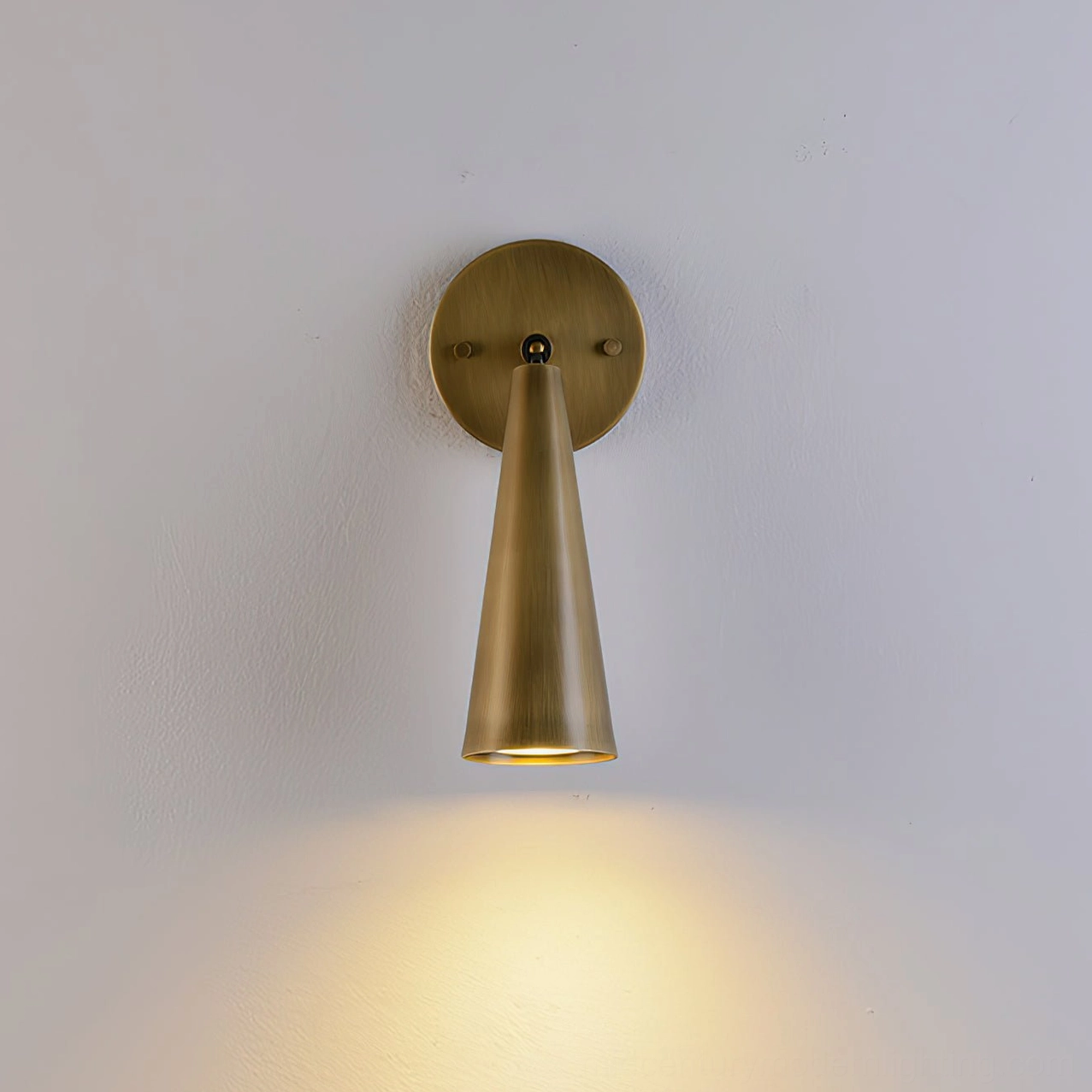 Donna mid-century modern wall sconce with sculptural cone shade and brass construction