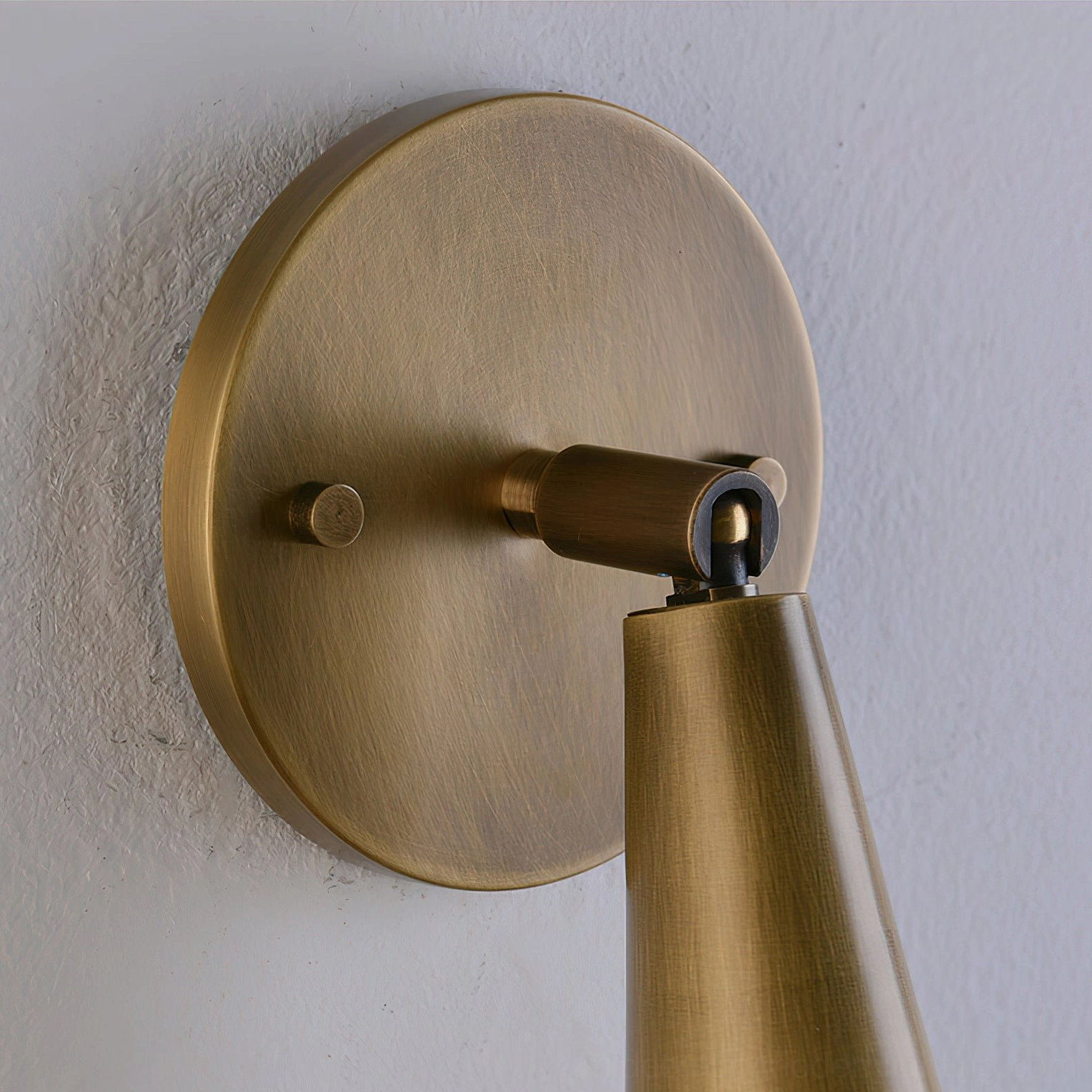 Donna sconce backplate close-up detail with brushed brass finish and mounting hardware
