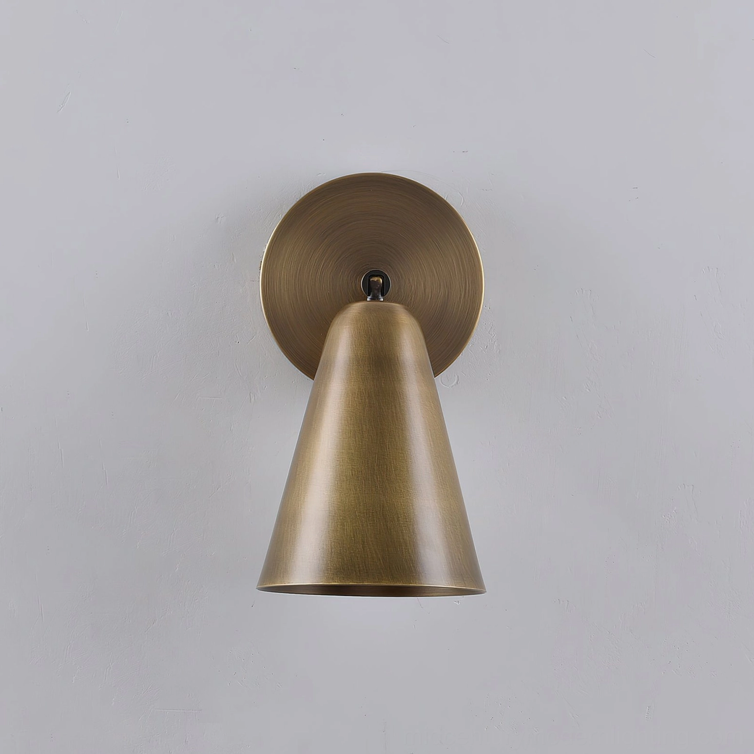 Donna adjustable wall sconce front facing view with elegant cone shade design