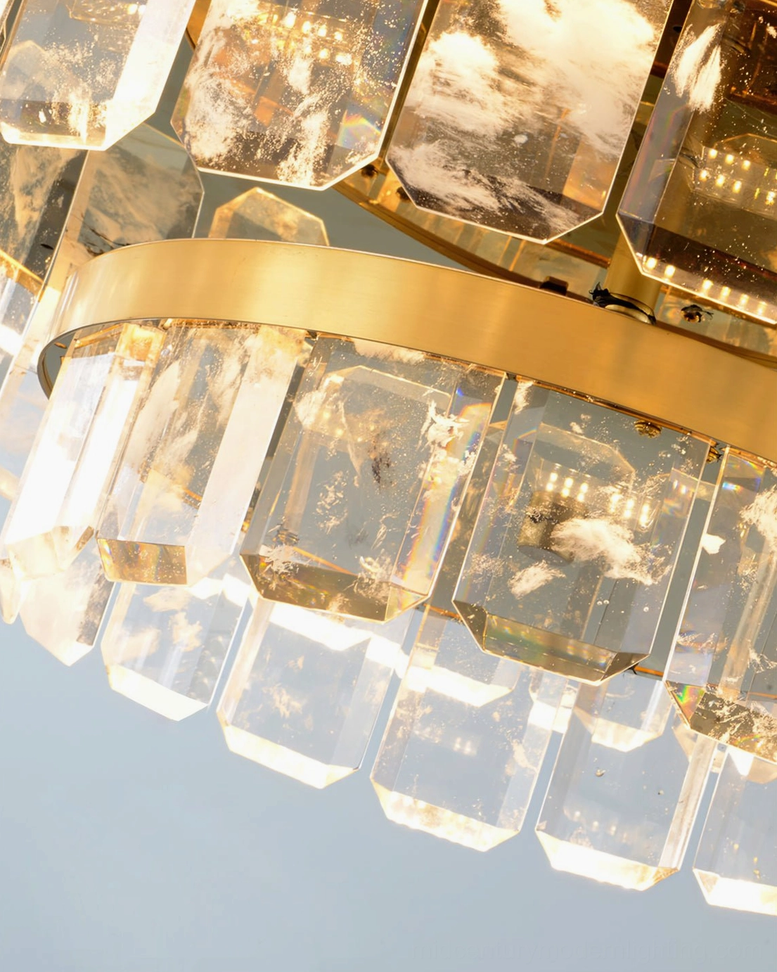 Doria crystal chandelier in neoclassical modern interior setting with sophisticated brass warm lighting