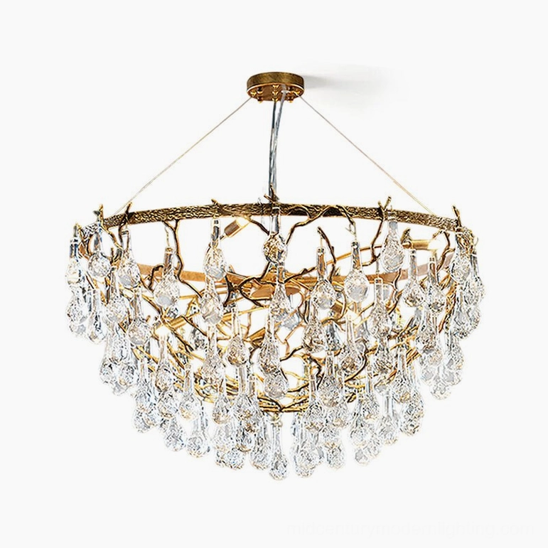 Doris antique brass chandelier illuminated detail showing lit G9 bulb glowing through brass components and warm crystal light refraction