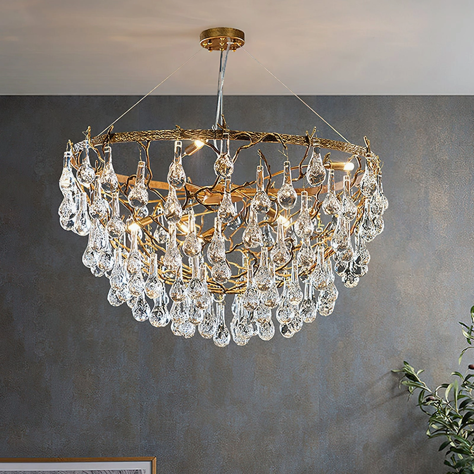 Luxury Doris brass chandelier overhead view displaying layered crystal drop tiers and warm prismatic light refraction in contemporary dining room