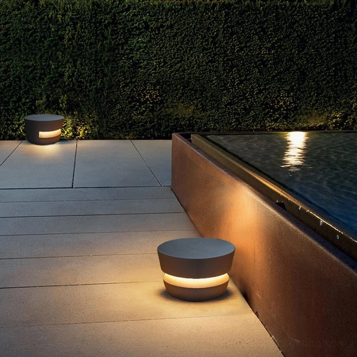 Two Dots minimalist lamps poolside - concrete patio with warm ambient uplight for outdoor entertaining