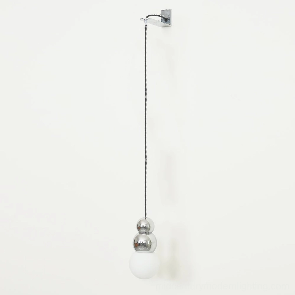 Double spherical glass wall sconce, stacked ball pendant design, artistic lighting installation