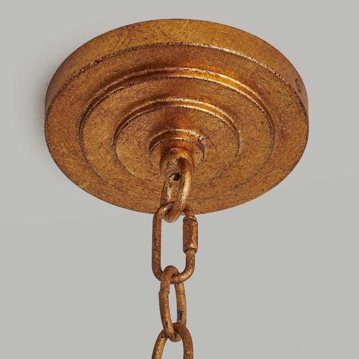 Brass-toned hanging chain and stepped metal canopy ceiling mount for drum cage chandelier installation