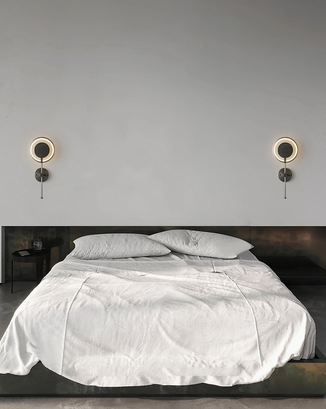 Pair of symmetrical LED ring wall lamps illuminating both sides of master bedroom headboard area