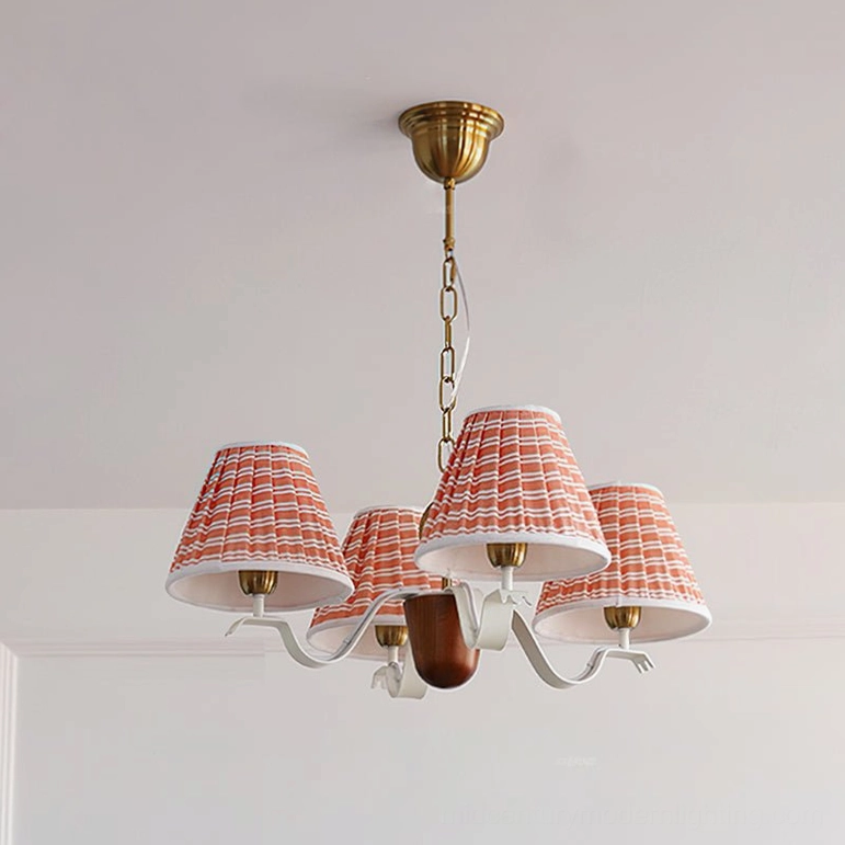 4-light beige fabric chandelier with gold brass and walnut wood accents, smaller scale version overhead