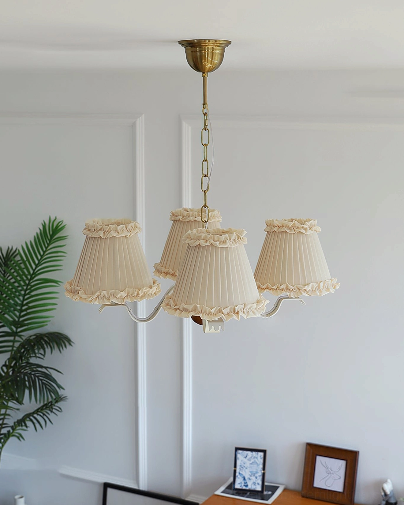 Mid-century modern fabric pendant light in home corner display with plant decor and off-white pleated shades