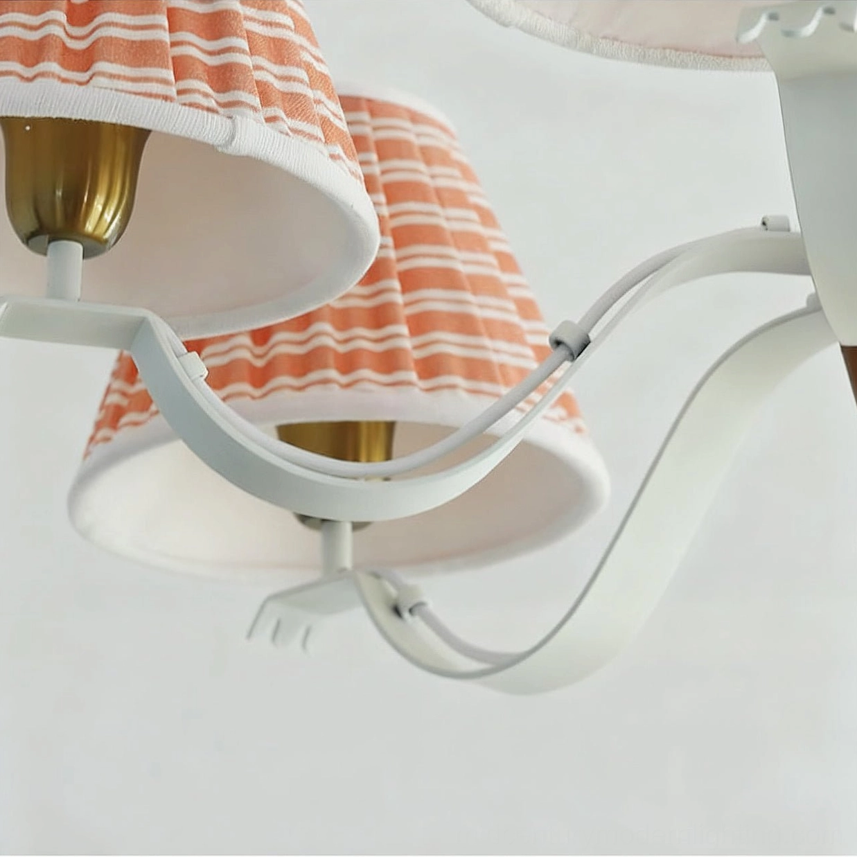 Fabric chandelier hanging mechanism, brass chain suspension, and mounting hardware detail view