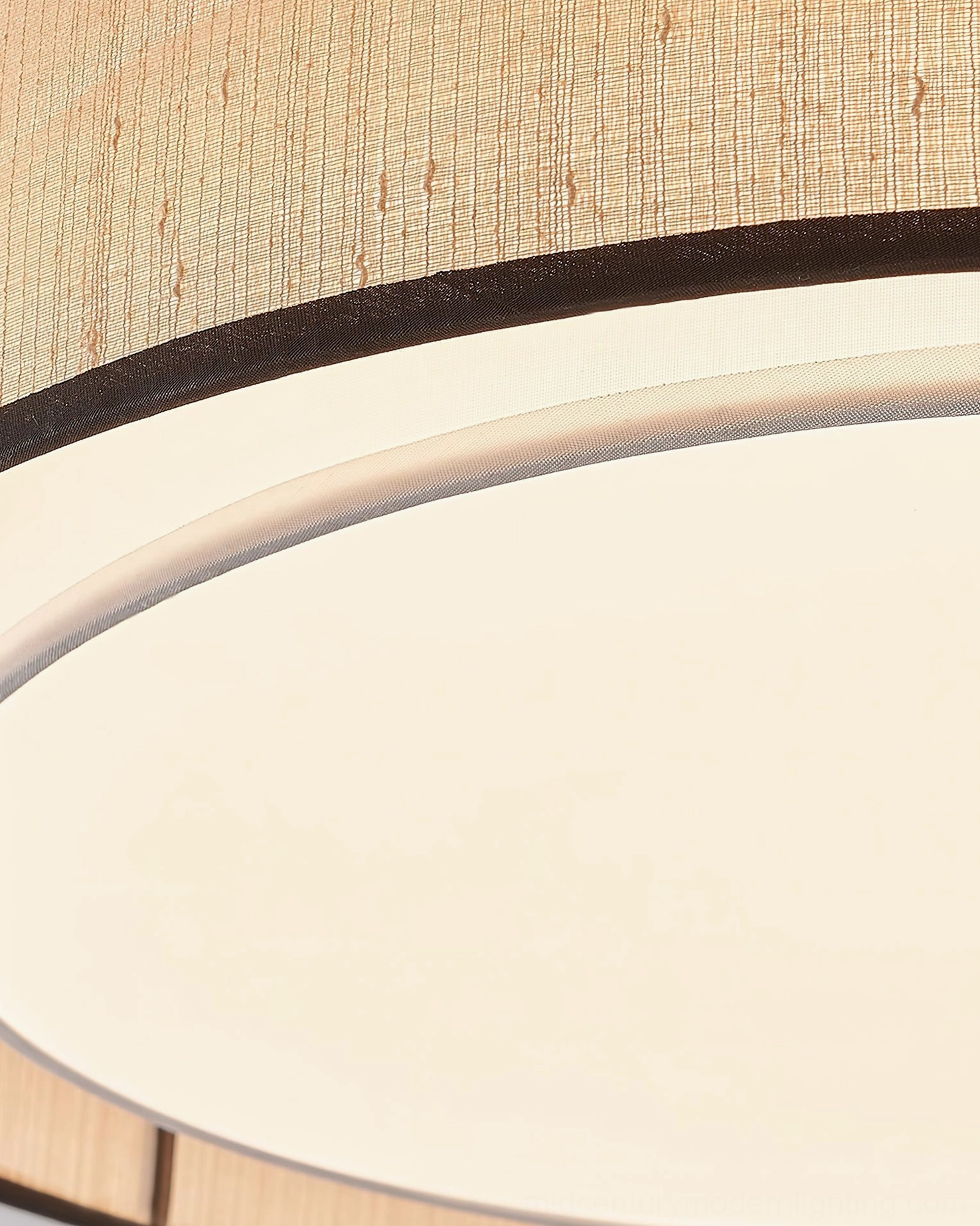 Duolla ceiling light illuminated showing warm glowing integrated LED diffused through fabric and acrylic layers