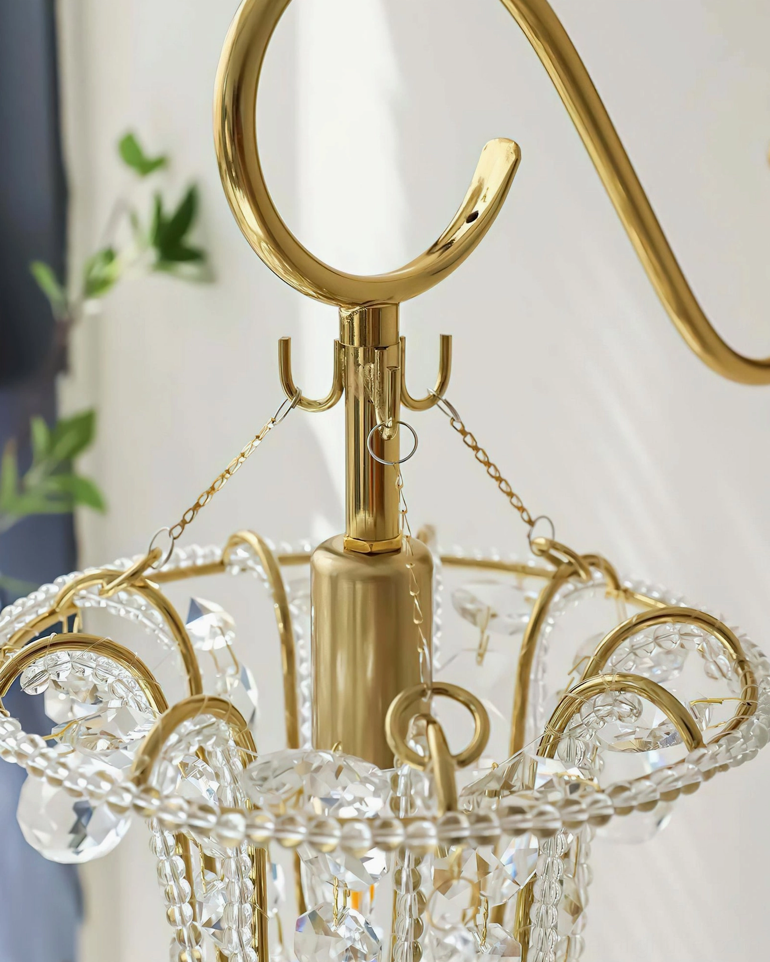 Top-down close-up view of Eilers wall sconce frame and crystal bead details, showcasing luxury craftsmanship and polished brass construction