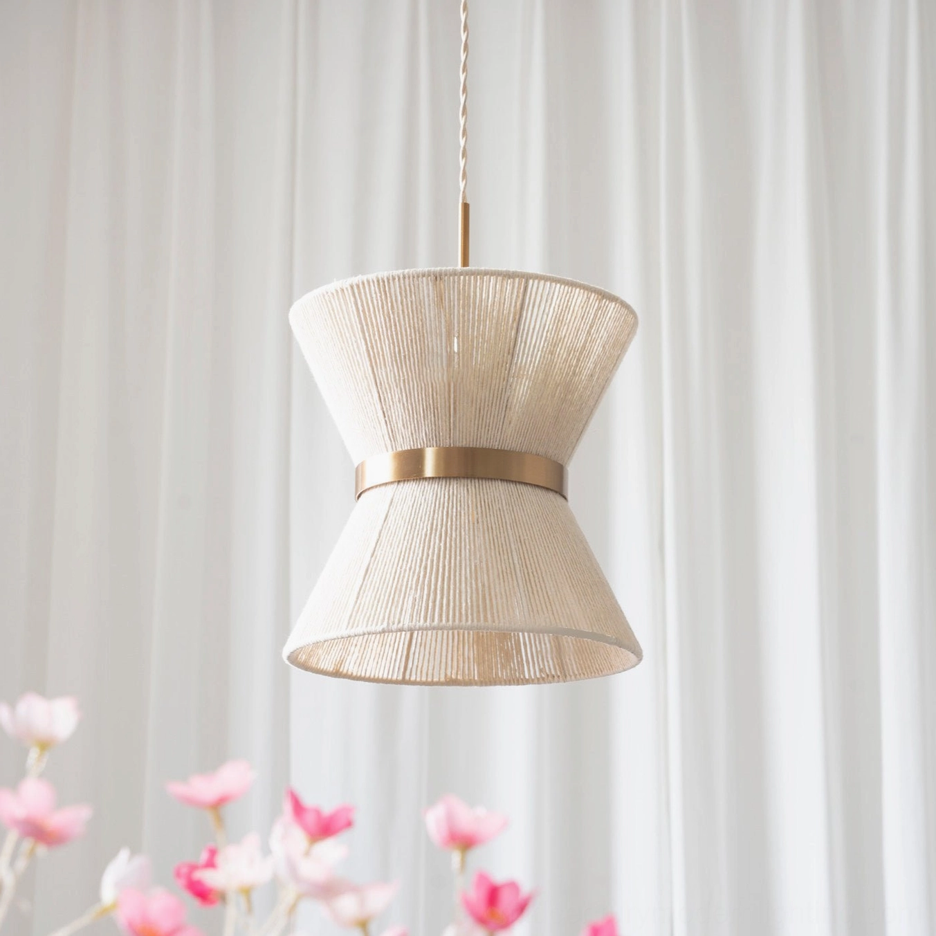 Elara hourglass woven pendant light with sculptural silhouette and beige cotton woven shade featuring refined gold metal accents on neutral background