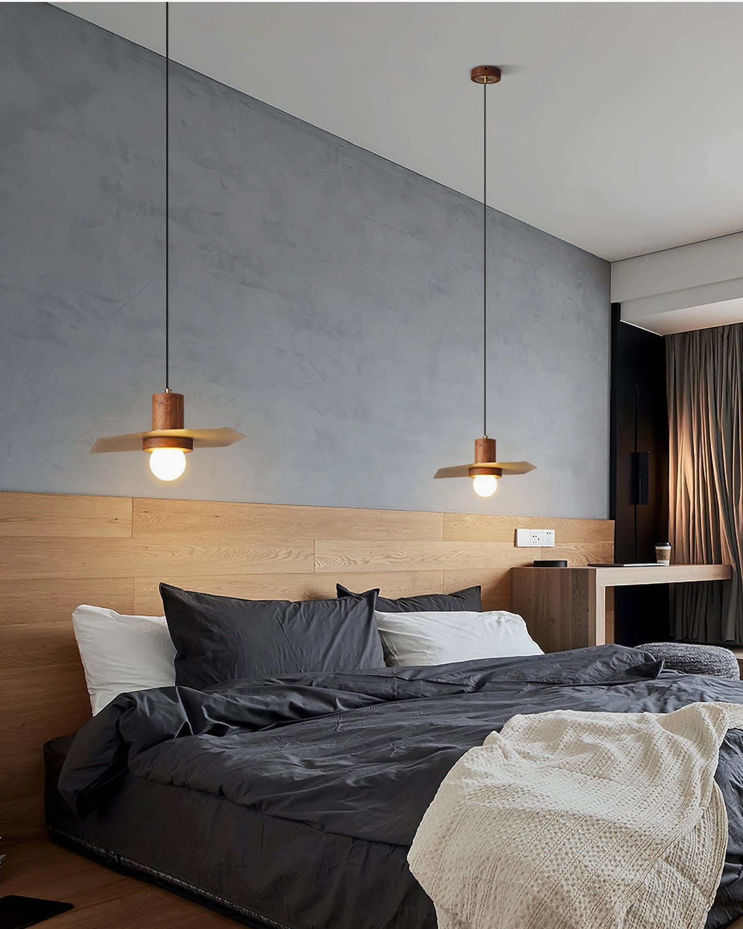 Pair of Elara pendant ceiling lights in master bedroom with wooden headboard and dark bedding