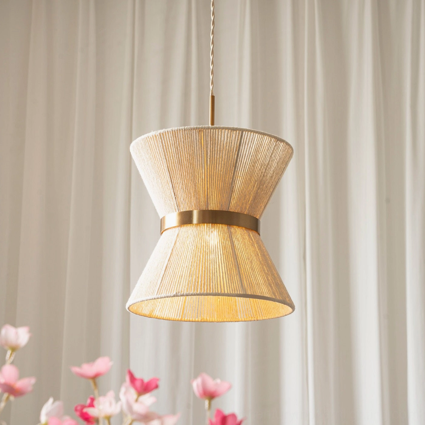 Close-up detail of Elara woven pendant light showing handwoven cotton rope texture and polished gold metal trim band