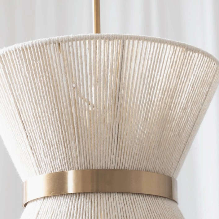 Elara woven pendant light with warm interior lighting, showing soft diffusion of light through natural cotton fibers and sculptural form