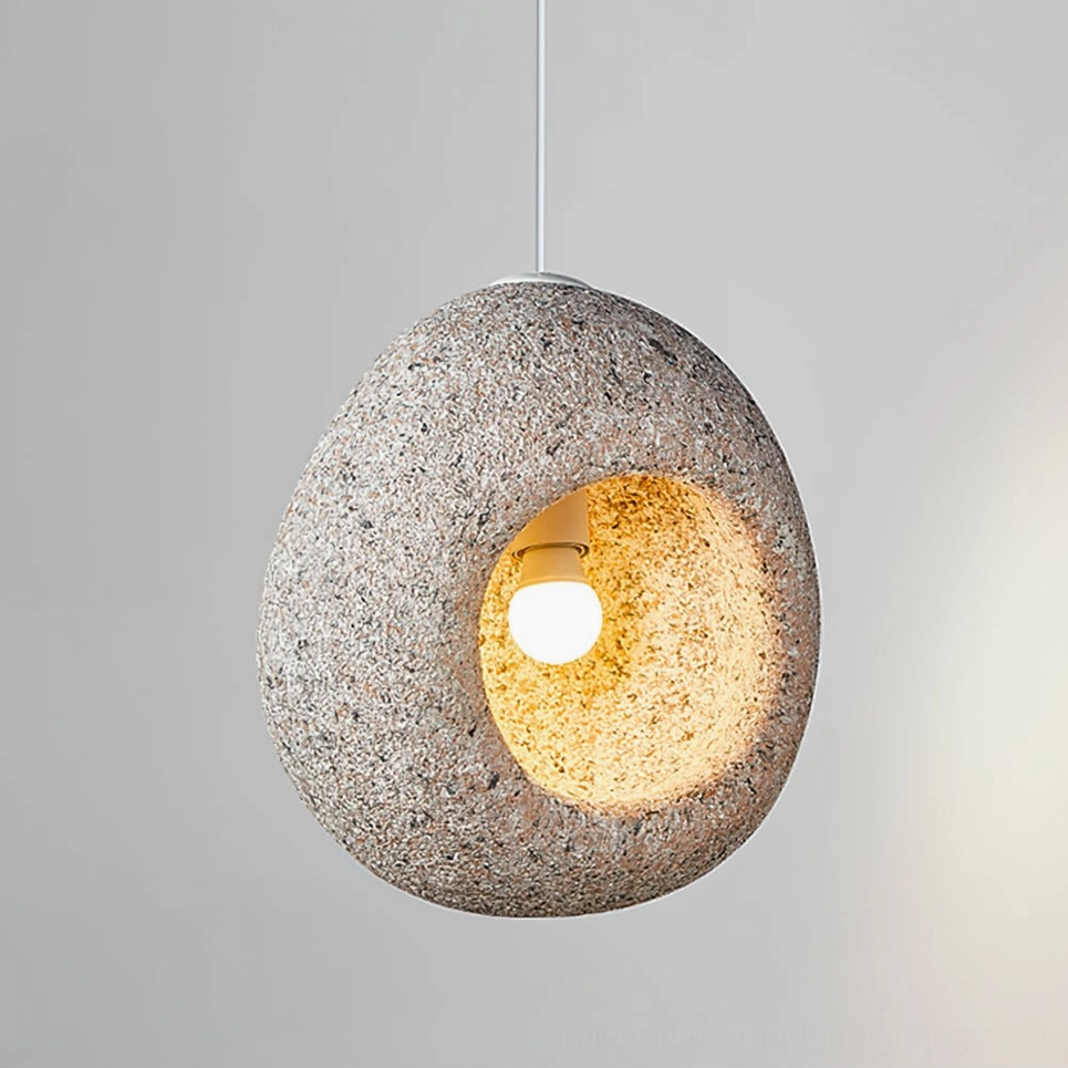 Elian stone pendant lamp front hanging view with speckled exterior and glowing warm light bulb