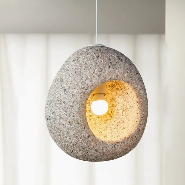 Elian light pink stone pendant lamp three-quarter view in contemporary minimalist interior setting