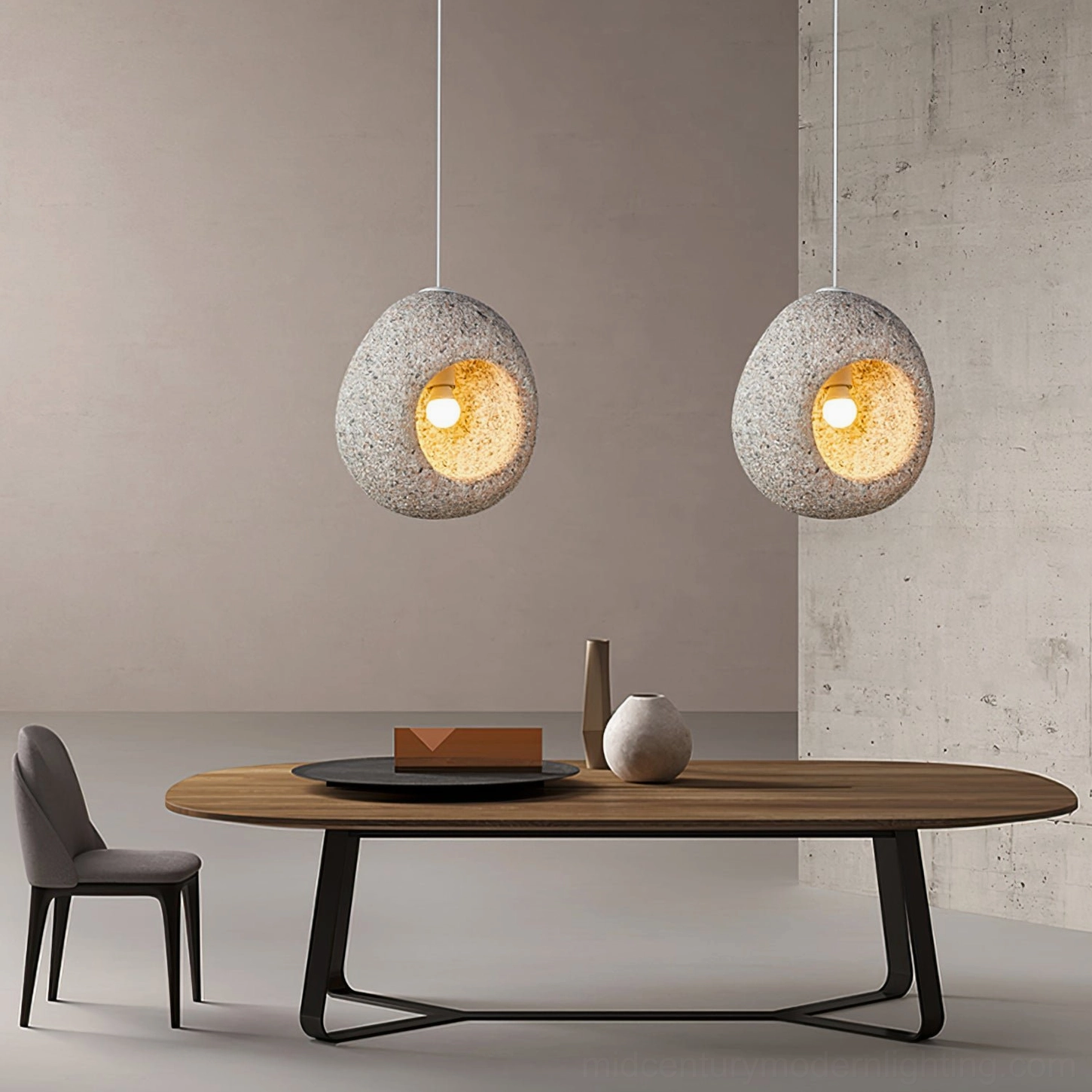 Two matching Elian stone pendant lamps in modern dining room with warm ambient lighting and neutral palette