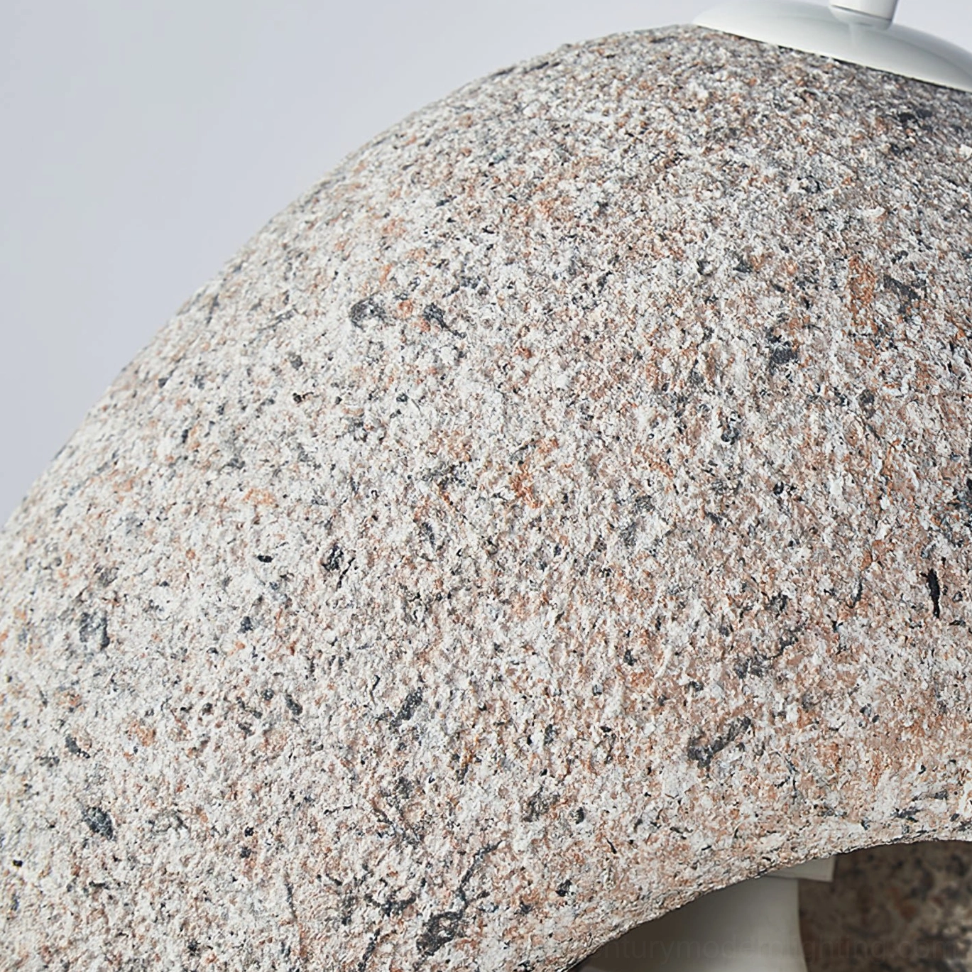Exterior macro side view of Elian pendant lamp showing coarse granite speckled stone surface texture