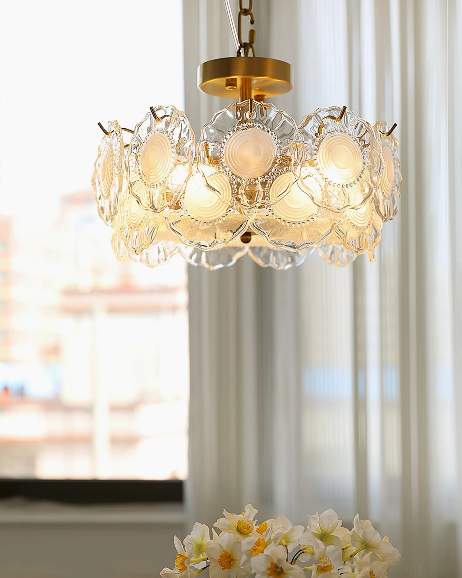 Illuminated ceiling lamp with embossed glass petal design near window with sheer curtains creating soft light