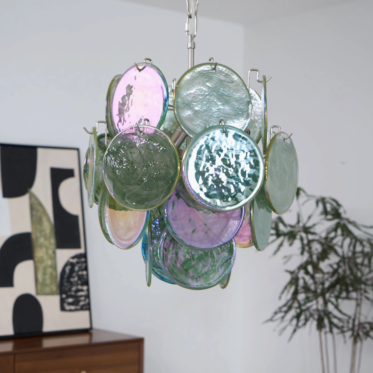 Close-up detail of iridescent green glass discs with swirled patterns artisan murano glasswork