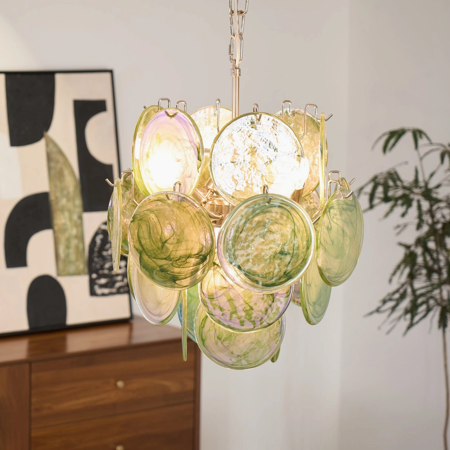 Emerald disc chandelier artistic detail iridescent glass light refraction patterns