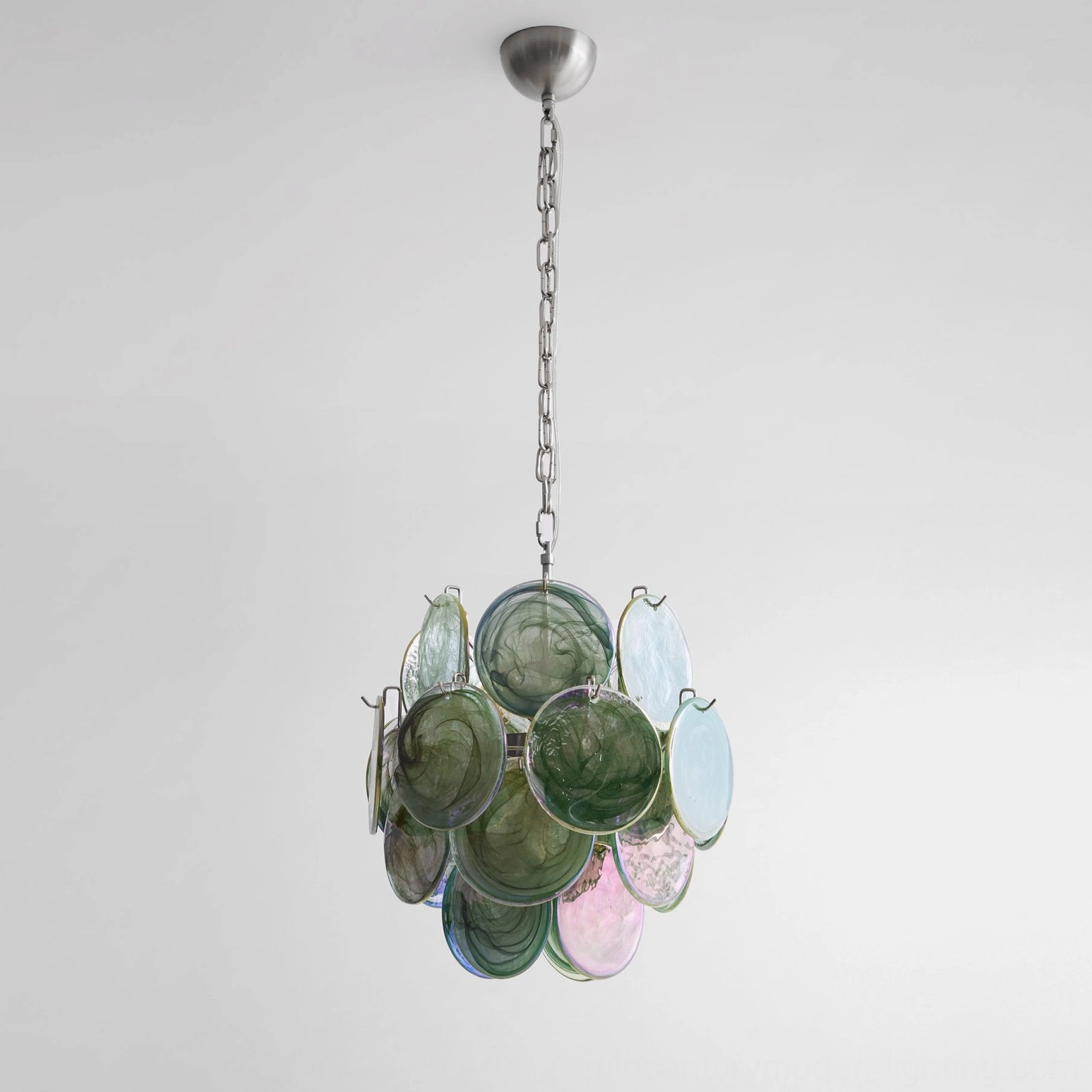 Compact emerald disc chandelier frontal view muted green-pink glass studio photography