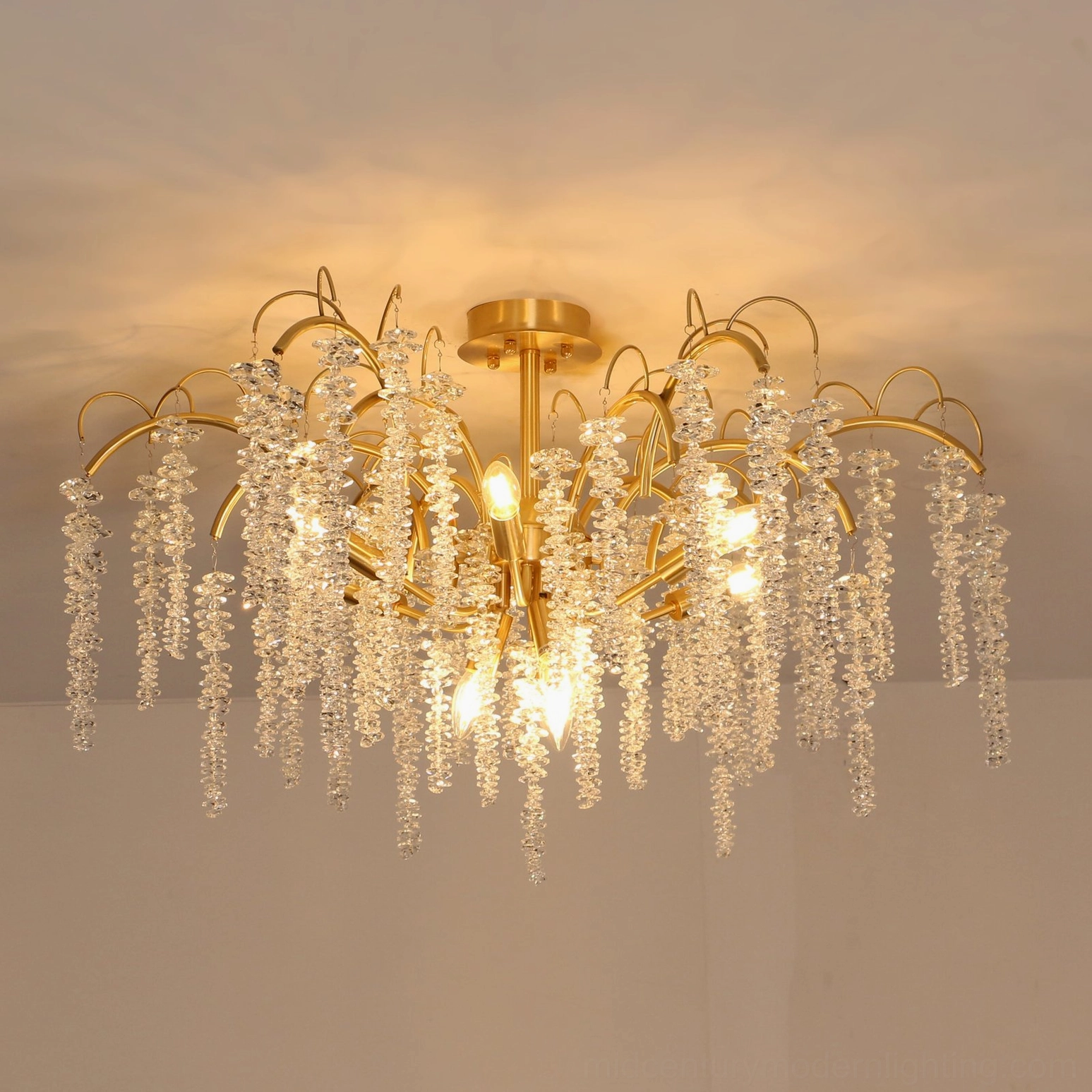 Emily Branch illuminated ceiling lamp flat front angle displaying gold finish and cascading crystal tassels