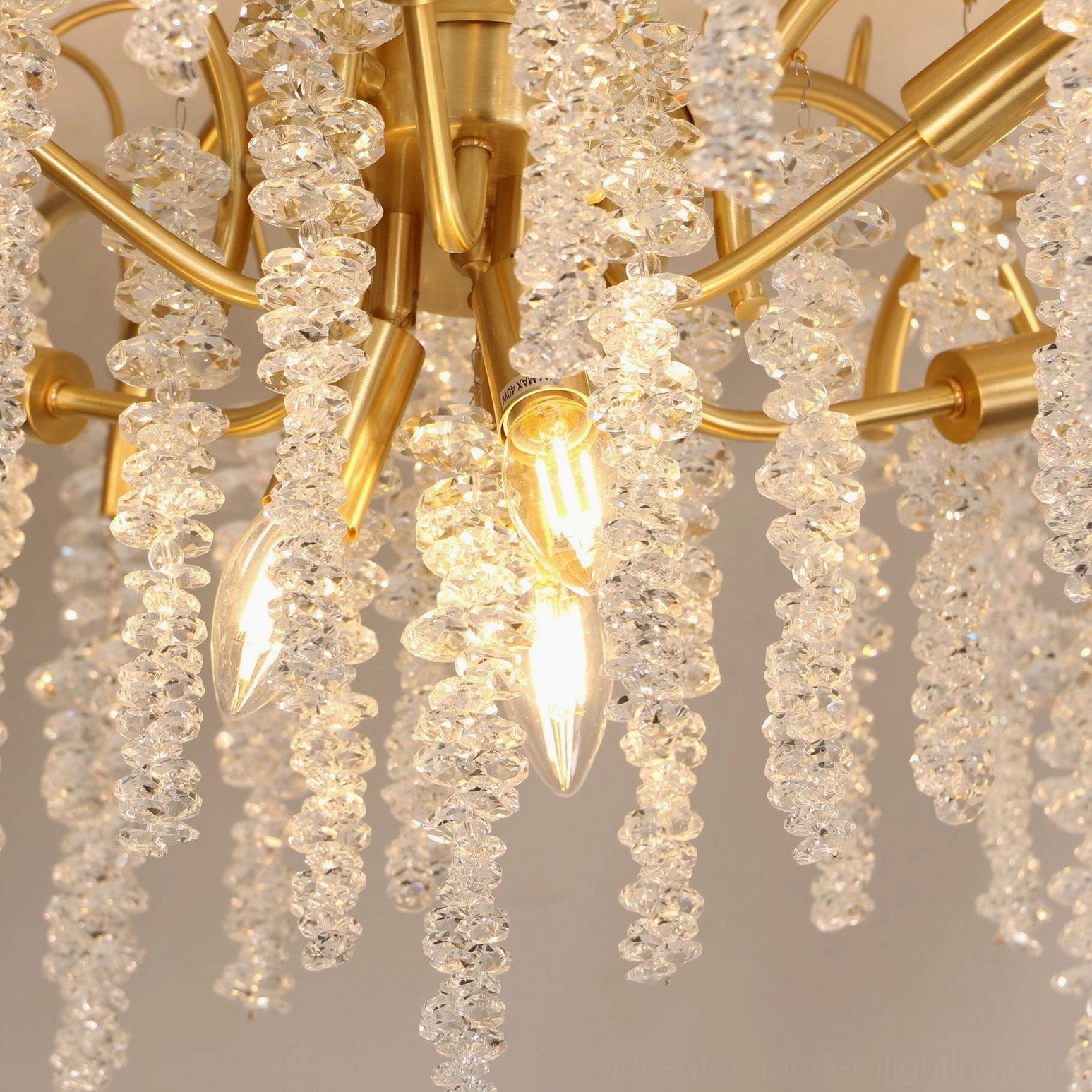 Close-up detail of Emily Branch lamp showing brass lamp holders, exposed candle bulbs, and clustered crystal bead construction