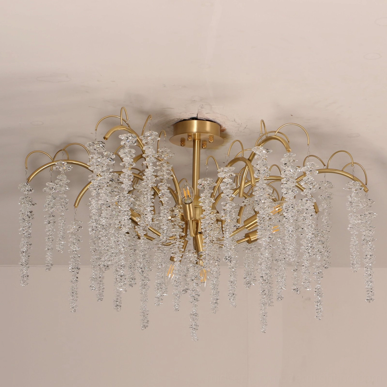 Overhead view of Emily Branch semi-flush crystal chandelier showing symmetrical brass frame and hanging crystal strands