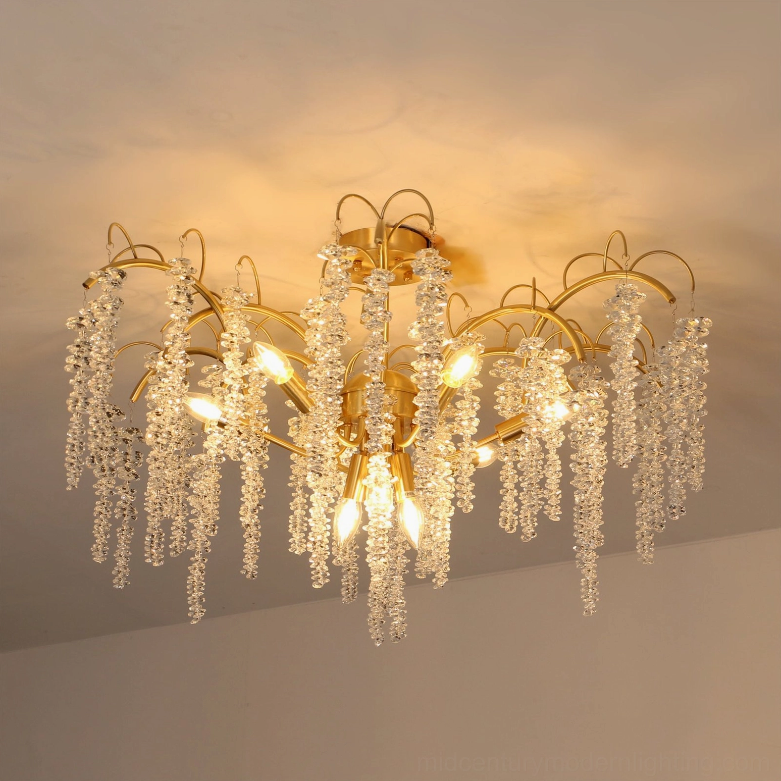 Fully lit Emily Branch crystal chandelier three-quarter front view showcasing elegant luxury multi-arm design