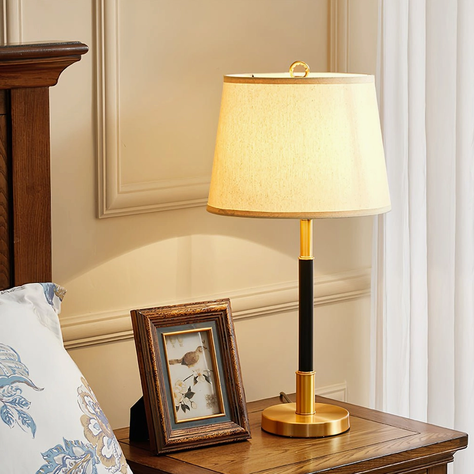 Empire Table Lamp on wooden bedroom nightstand with photo frame and warm neutral wall background