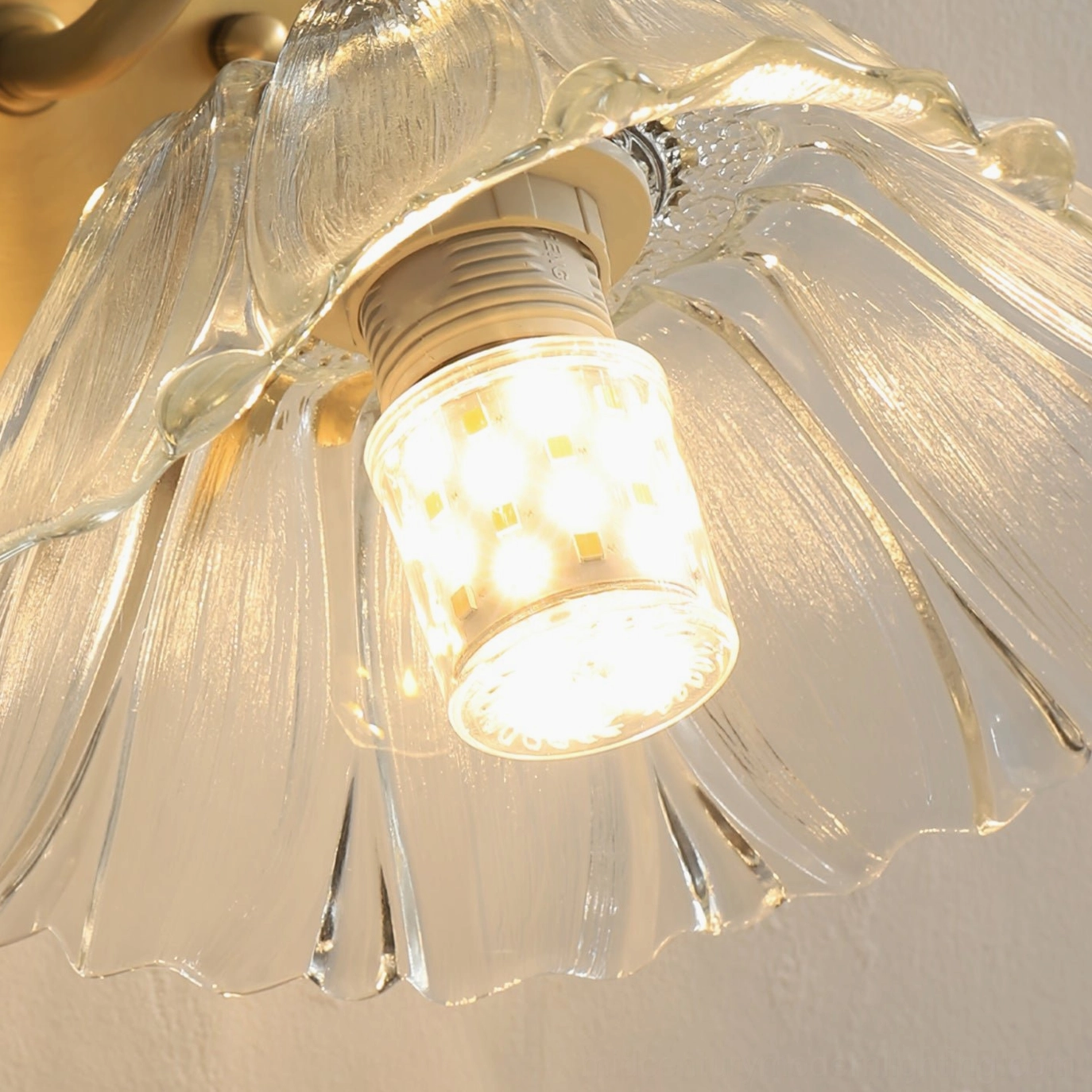 Ercole lampshade close-up detail with LED warm bulb and clear fluted glass petal construction