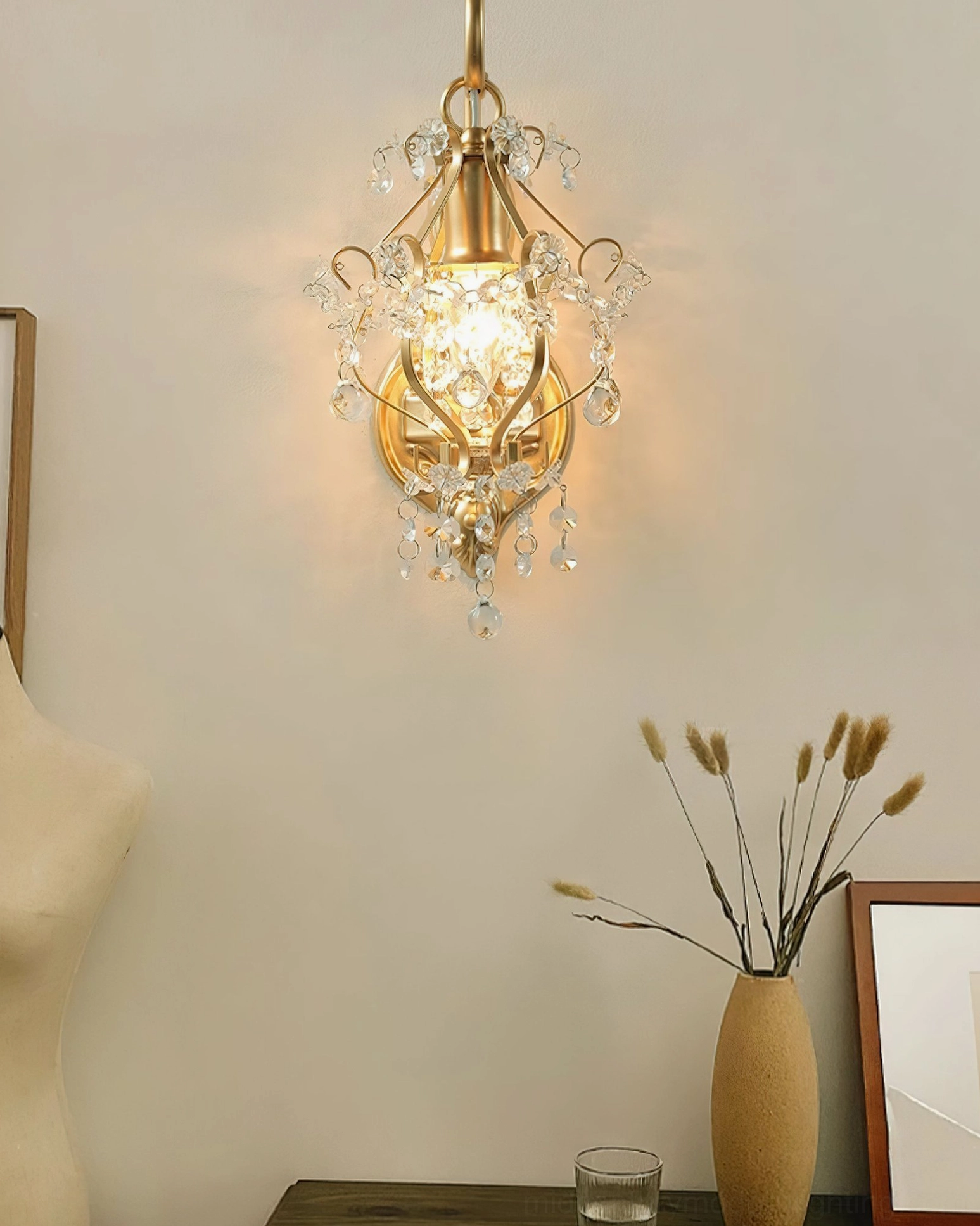 Elegant European-style crystal wall lamp on table display with dried flower arrangement and luxury lighting ambiance