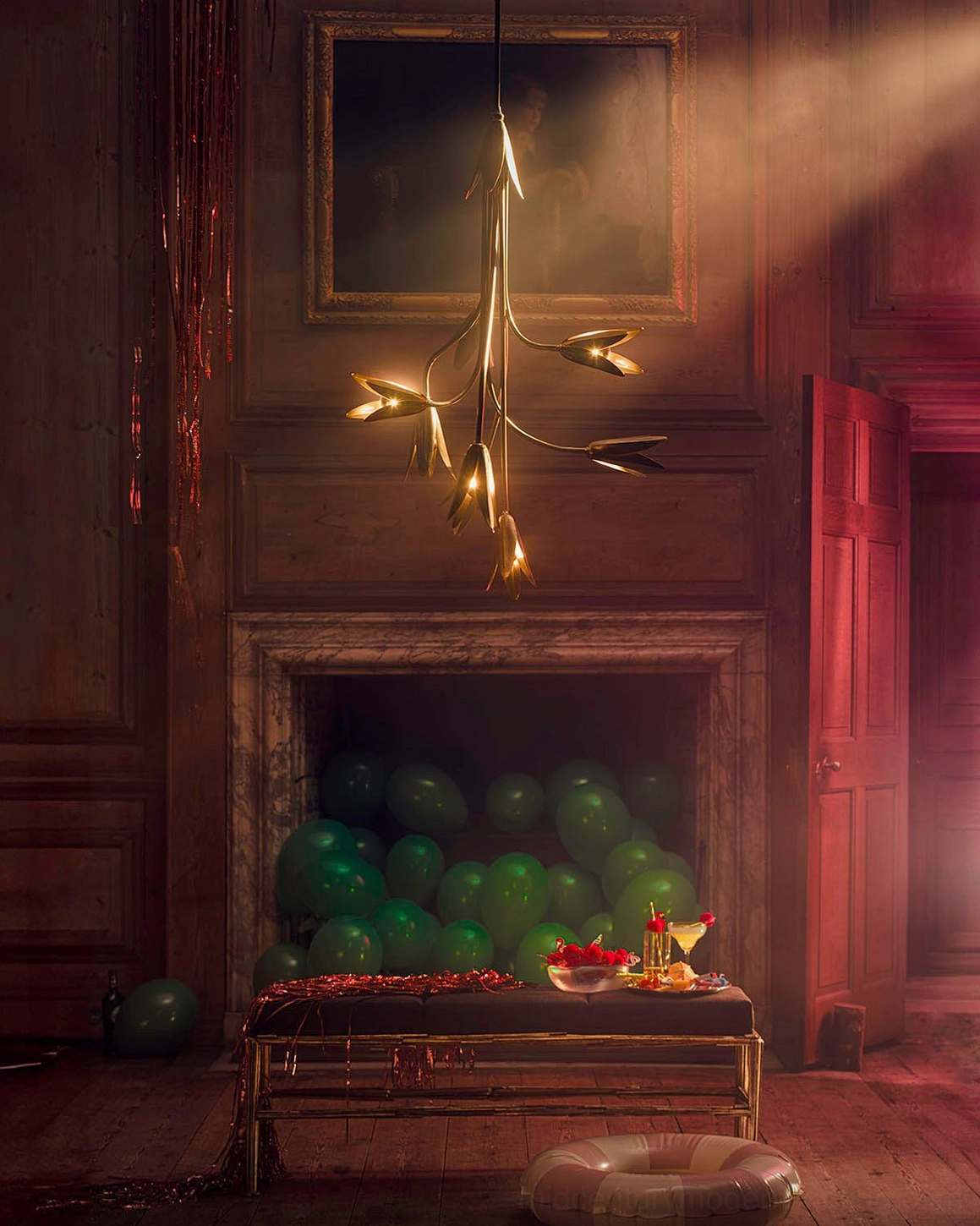 Evadne brass tulip chandelier illuminated in vintage luxury living room with fireplace and festive decor