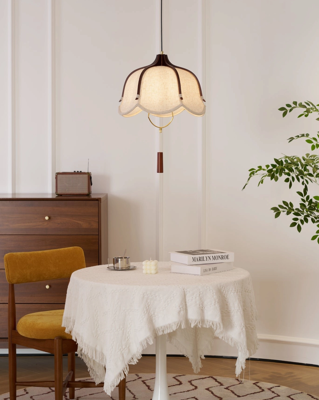Evelyn scalloped fabric pendant light in cozy dining nook with round wooden table and wall art